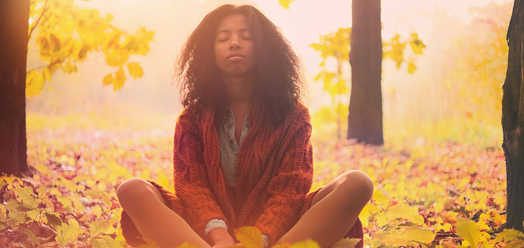 Image of African descent woman enjoying autumn sunlight