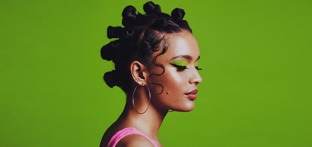 Image of Woman using product to hold down her hair edges