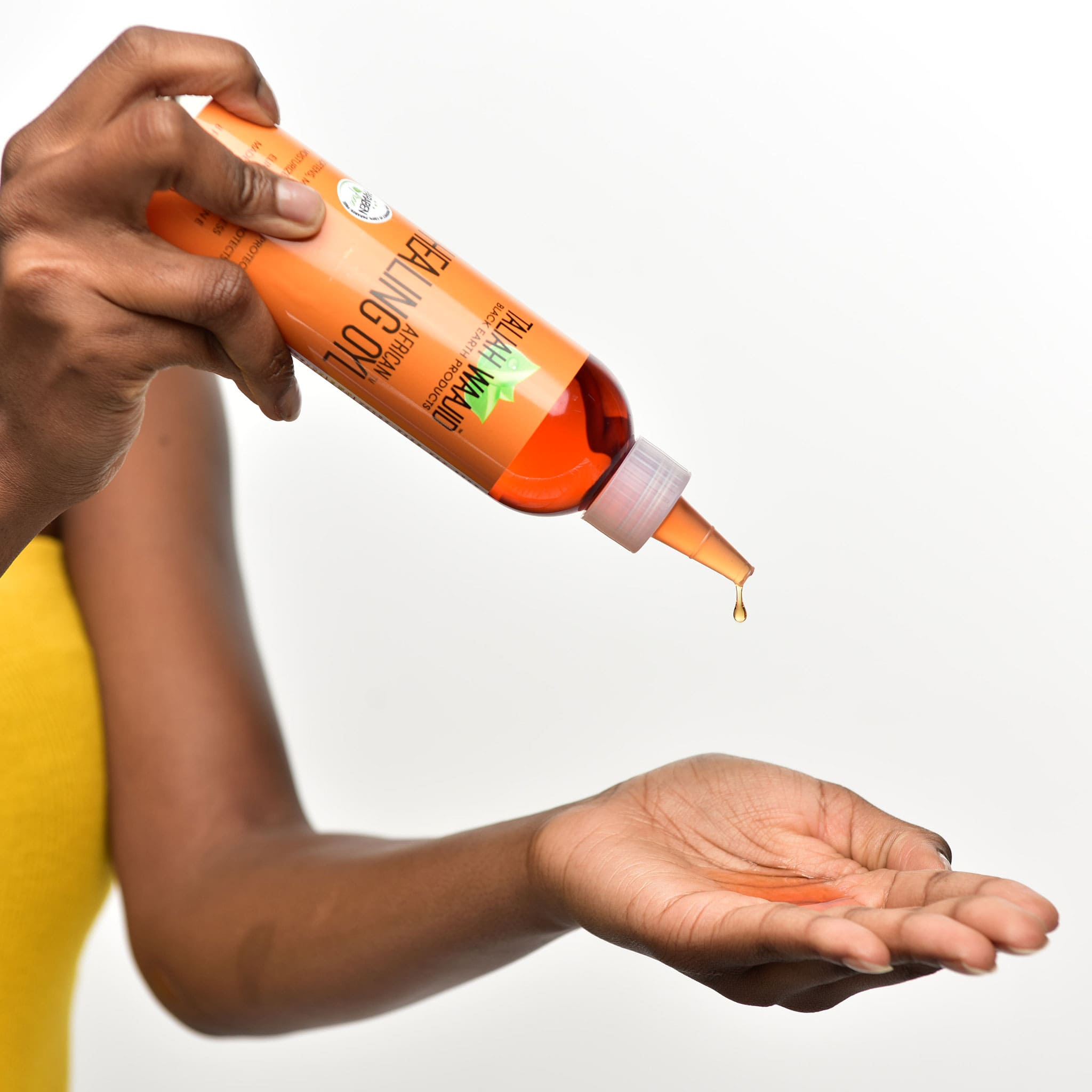Image of Woman pouring African Healing Oyl in her hand